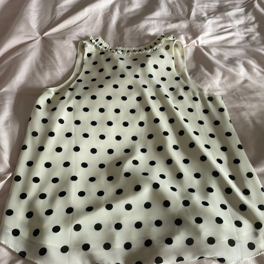 Black and cream polkadot, high neck blouse.